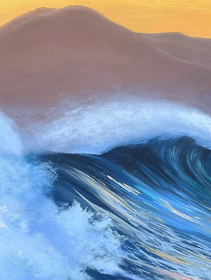 Close detail: the curling crest of the wave, white foam rolling over a dark teal wall against a dusky mountain