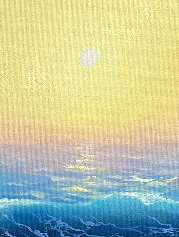 Close detail: the pale sun low in a yellow sky, its light running down to the water in a broken path