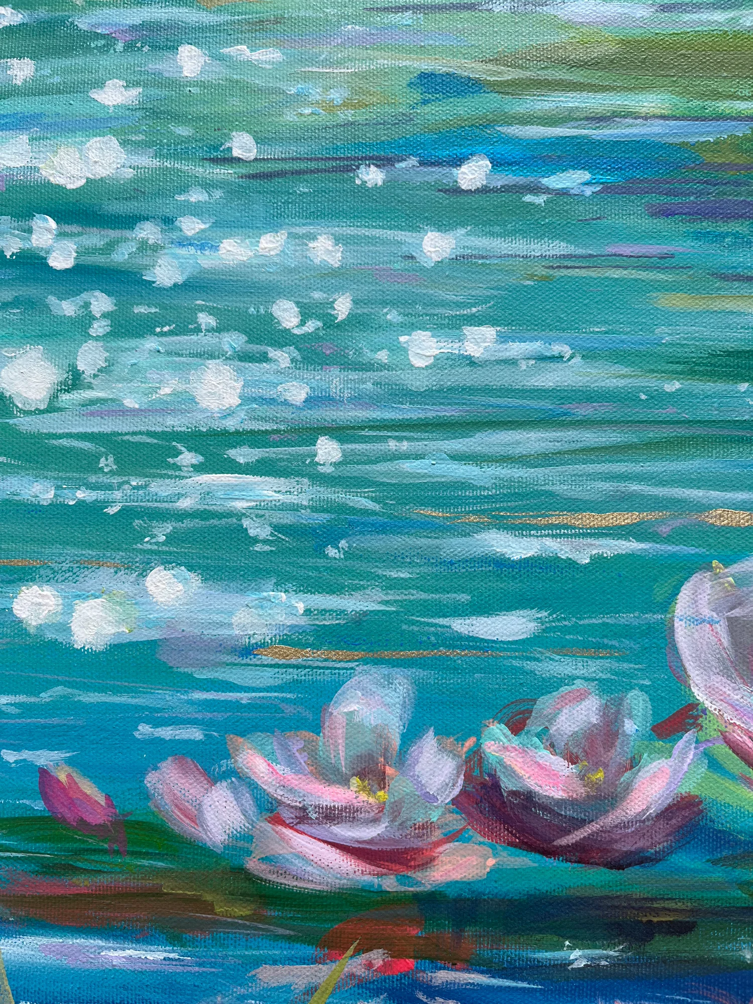 Close detail: turquoise water scattered with white flecks of sunlight, pink lilies gathered along the lower edge