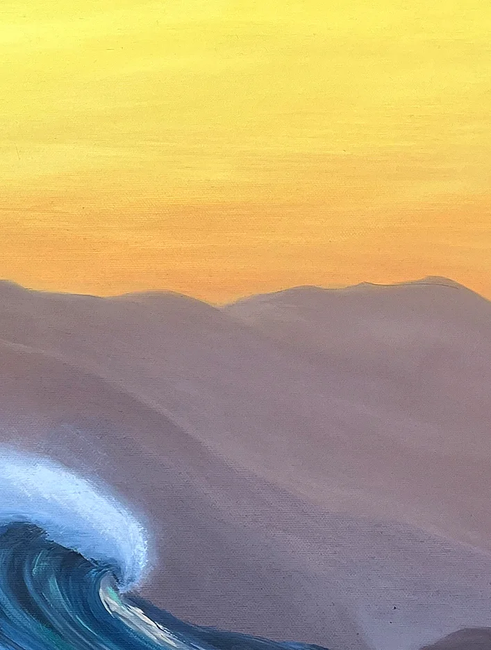 Close detail: the soft mauve outline of the mountains against a golden yellow sky, the tip of the crest below